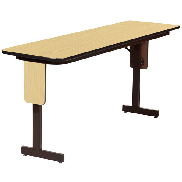 A rectangular Correll seminar table with a black panel leg frame and a fusion maple finish top.