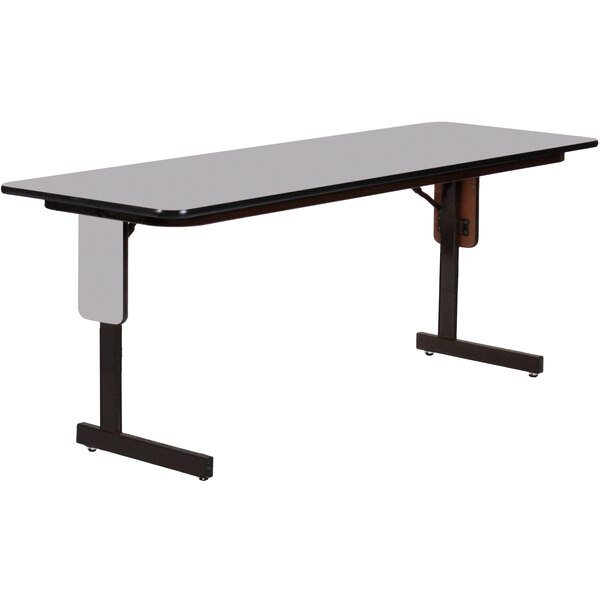 A rectangular table with a gray granite top and black panel legs.