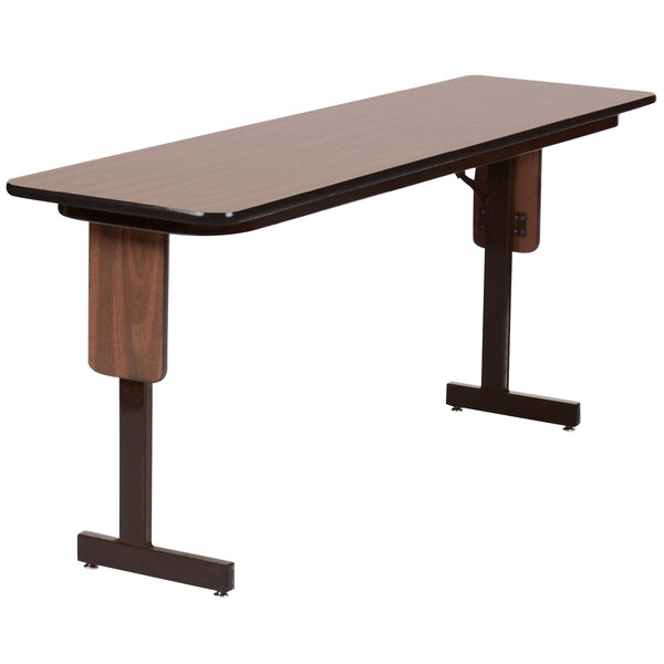A brown rectangular Correll seminar table with black panel legs.