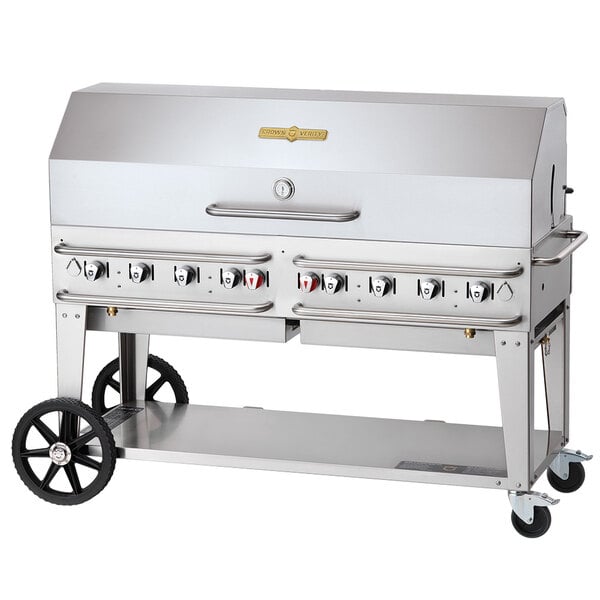 A large stainless steel Crown Verity outdoor rental grill with a single roll dome and wheels.
