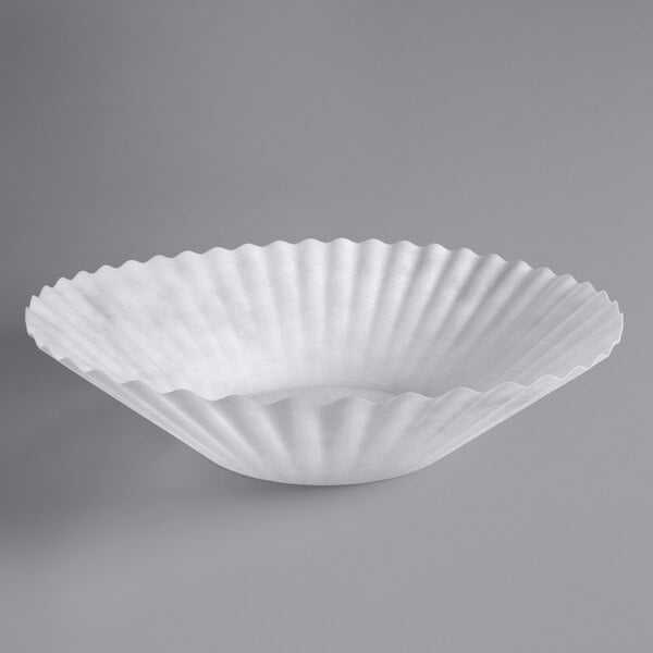 A white paper coffee filter with a scalloped edge.