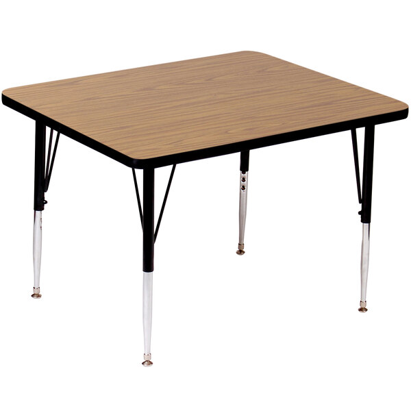 A Correll rectangular activity table with medium oak legs and a wooden top with black edges on it.