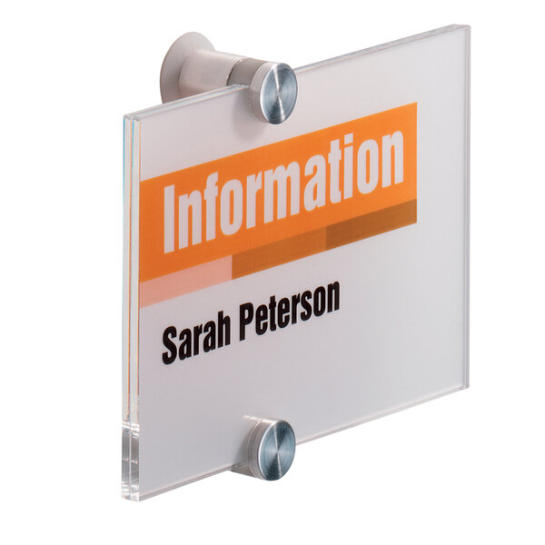 A close-up of a clear acrylic sign with yellow and orange text that reads "information"