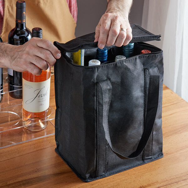 A person opening a Franmara reusable wine bag with 6 bottles inside.