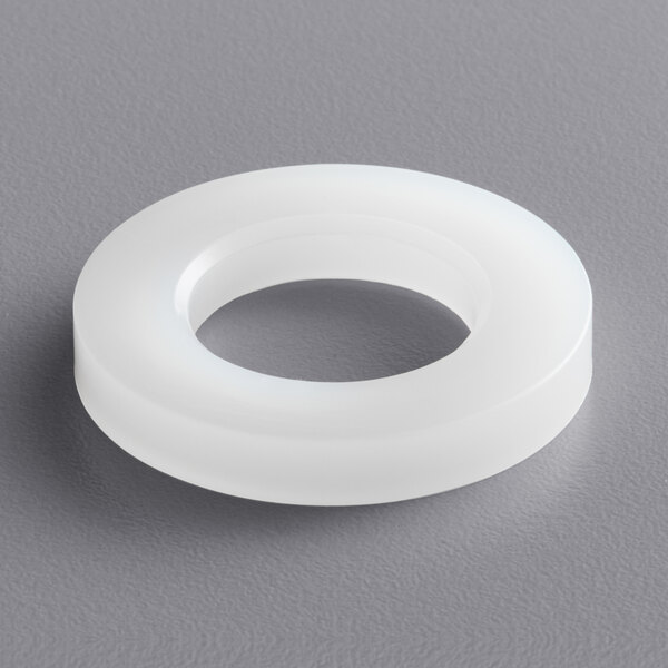 A white nylon bushing with a hole in the center.