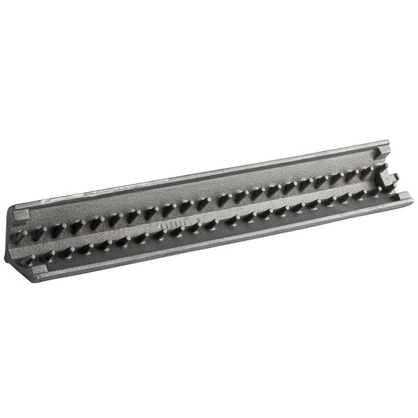 A metal rail with spikes and holes.