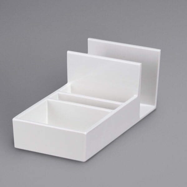 A white melamine condiment caddy with two compartments on top.