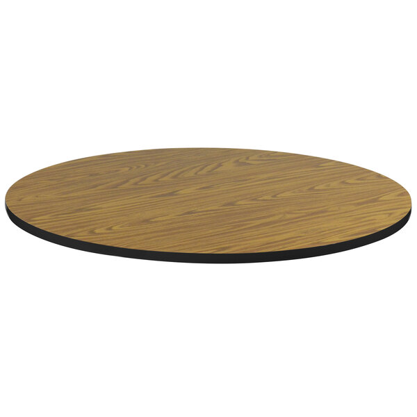 A Correll round wood table top with black edge.