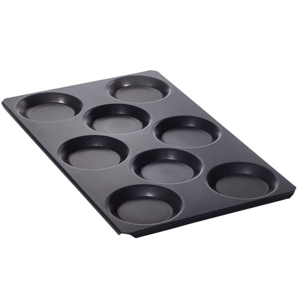 A black non-stick baking tray with 8 molds.