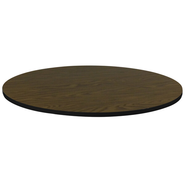 A Correll brown walnut finish round table top with black edge.