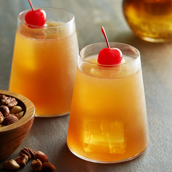 Two glasses of DaVinci Gourmet Amaretto-flavored drinks with cherries on top.