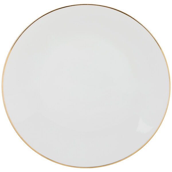 A white porcelain dinner plate with a gold rim.