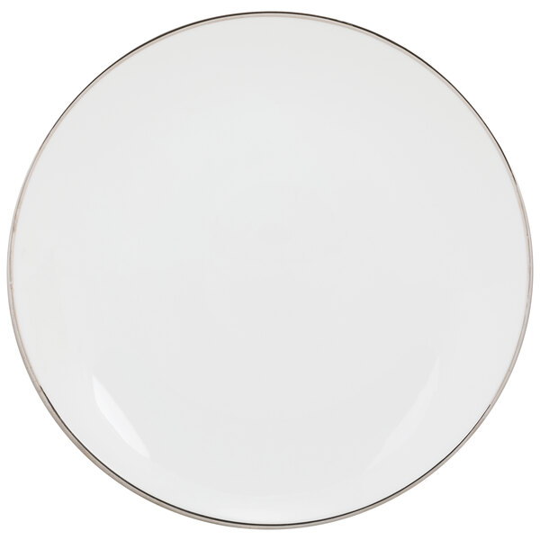 A white porcelain luncheon plate with a silver rim.