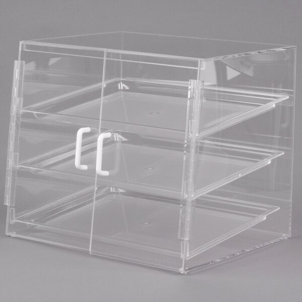 A clear plastic slanted display case with three shelves on a counter.