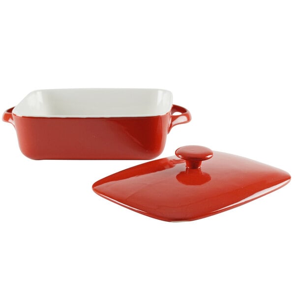 A red and white rectangular ceramic baker with a red lid.
