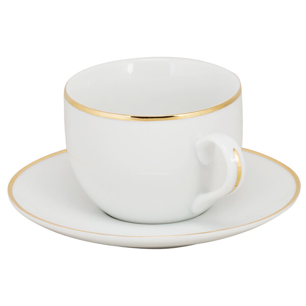 A white cup and saucer with gold trim.