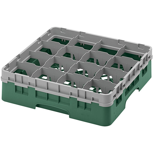 A green and grey plastic Cambro glass rack with sixteen compartments.
