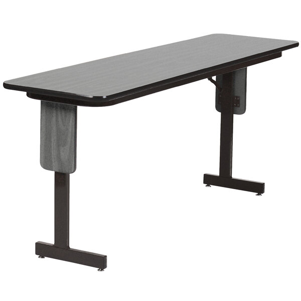 A rectangular New England driftwood finish seminar table with black panel legs.