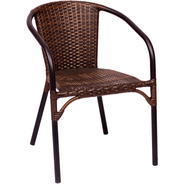 A BFM Seating Marina brown synthetic wicker arm chair with black legs.