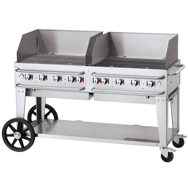 A large Crown Verity outdoor grill with a lid and wheels.