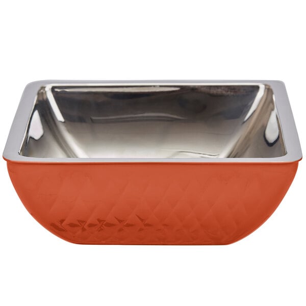 A close up of a square orange Bon Chef bowl with a silver rim.