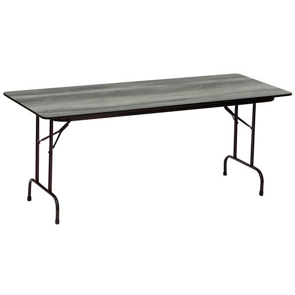 A Correll rectangular folding table with a New England driftwood finish on black legs.