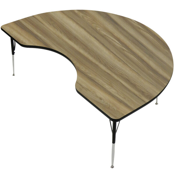 A Correll kidney-shaped activity table with a hickory finish and adjustable height.