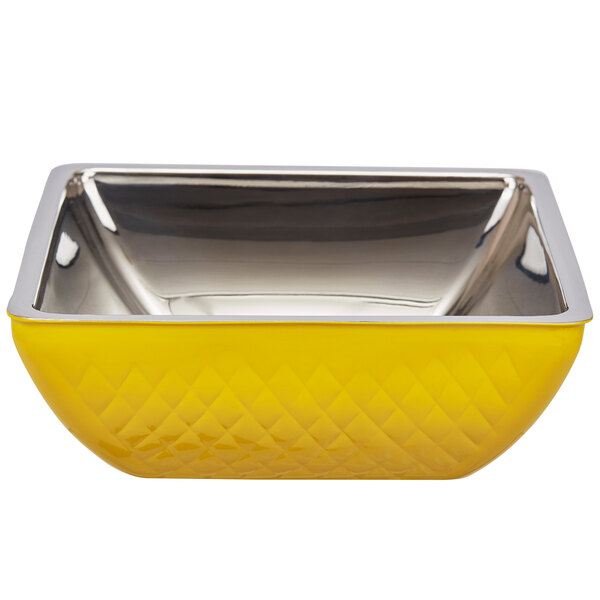 A yellow square bowl with silver trim and a metal handle.