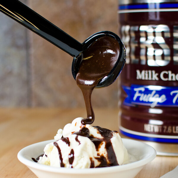 A black Cambro Camwear ladle pouring chocolate sauce into a bowl of ice cream.