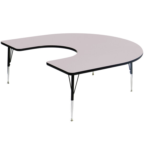 A gray granite horseshoe-shaped Correll activity table with adjustable legs.