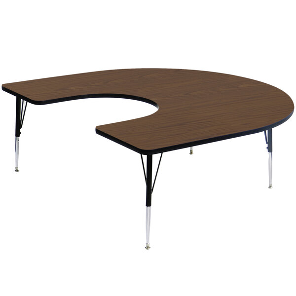 A walnut-finished half-moon shaped Correll activity table with adjustable legs.