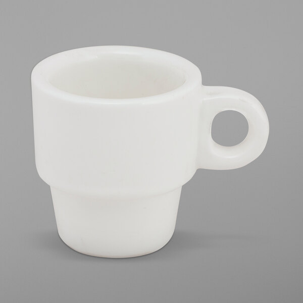 A white cup with a handle.