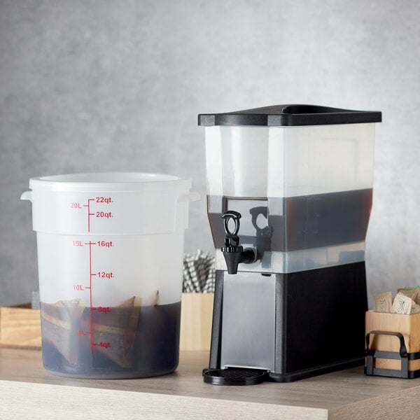 A Crown Beverages plastic cold brew system on a counter with black liquid inside.