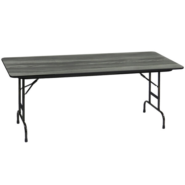 A rectangular black Correll folding table with metal legs and a gray top.