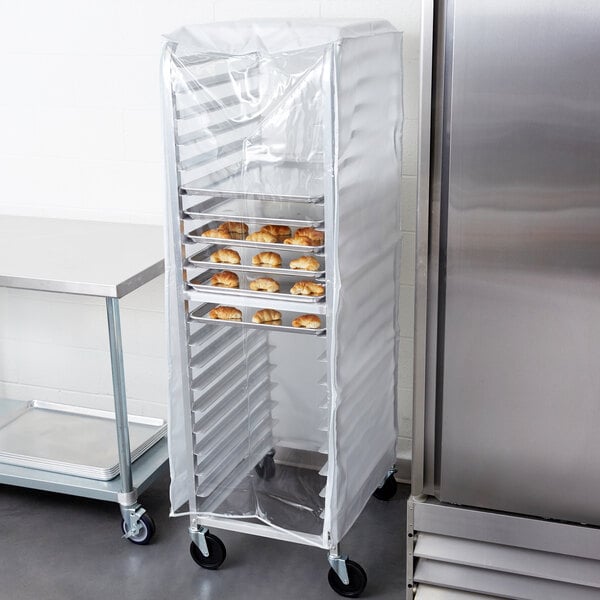 An Advance Tabco heavy duty bun pan rack cover with clear front on a cart with trays of food.