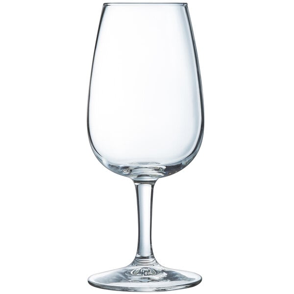 An Arcoroc clear wine taster glass with a stem on a white background.