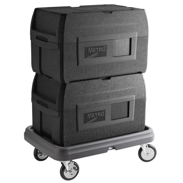 Two Metro Mightylite BigBoy food pan carriers with black lids on a dolly.