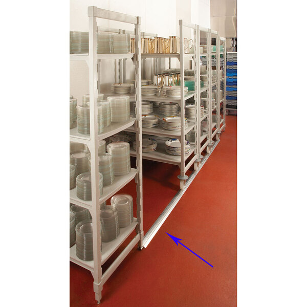 A Cambro Camshelving track kit with shelves stacked with plates.