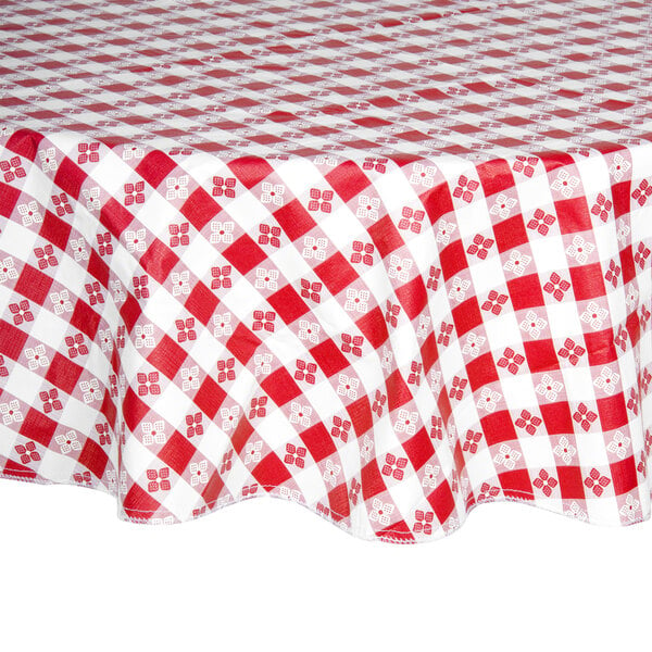 A red and white checkered Intedge vinyl table cover on a round table.