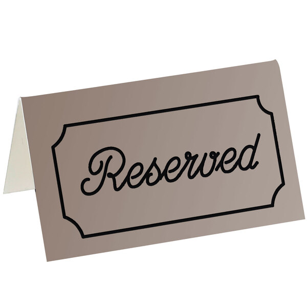 A brown Cal-Mil double-sided "Reserved" tent sign on a table.