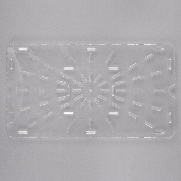 A close-up of a clear plastic Carlisle drain tray with holes in it.