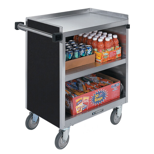A Lakeside stainless steel utility cart with a black laminate finish and enclosed base holding drinks and snacks.