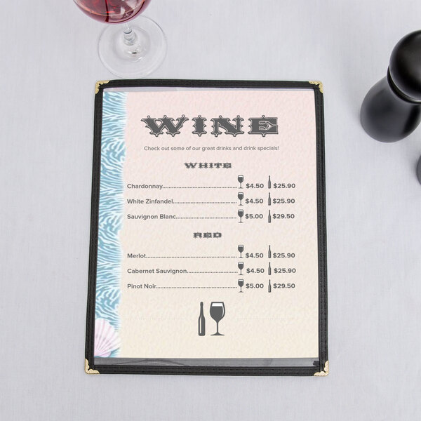 An 8 1/2" x 11" seafood menu with a shell design on a table with a glass of wine.