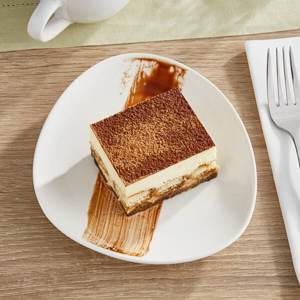 A piece of cake on an Acopa Nova cream white stoneware plate.