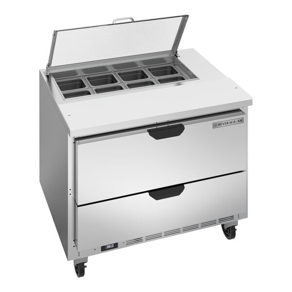A stainless steel Beverage-Air sandwich prep table with clear lids open.