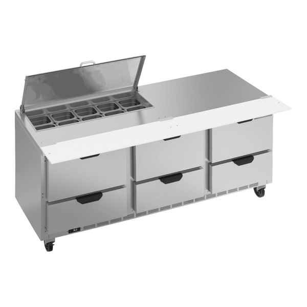 A large stainless steel counter with six drawers.