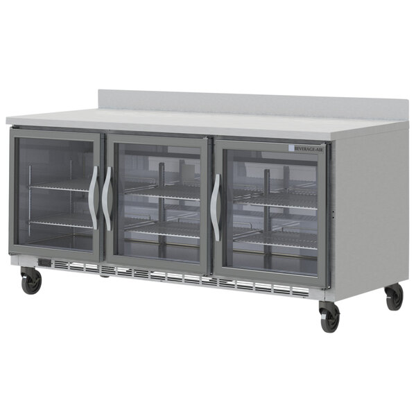 A Beverage-Air stainless steel worktop refrigerator with three doors.