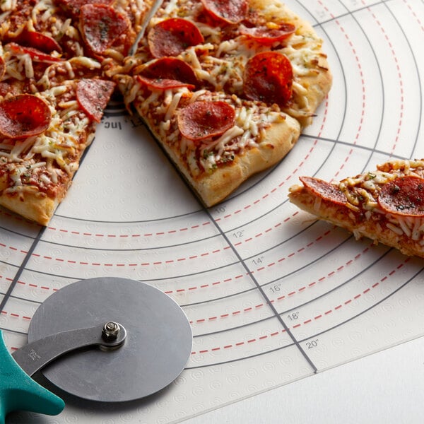 An American Metalcraft pizza slice cutting guide being used to cut a pizza on a cutting board.