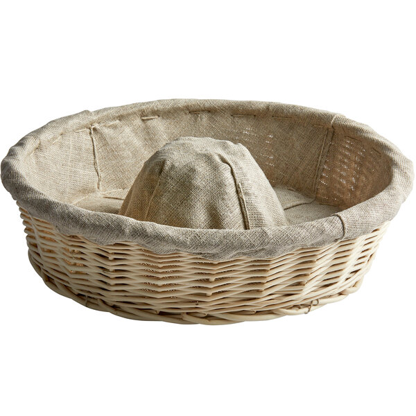 A Matfer Bourgeat round wicker proofing basket with a linen liner.