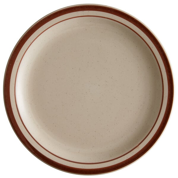 A close-up of a Libbey narrow rim stoneware plate with brown bands on a white surface.